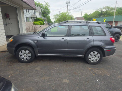 2005 Mitsubishi Outlander for sale at Maximum Auto Group II INC in Cortland OH