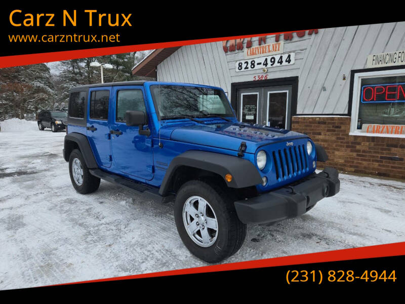 2014 Jeep Wrangler Unlimited for sale at Carz N Trux in Twin Lake MI