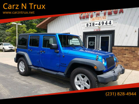 2015 Jeep Wrangler Unlimited for sale at Carz N Trux in Twin Lake MI