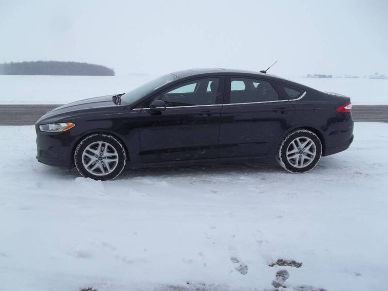 2015 Ford Fusion for sale at Howe's Auto Sales in Grelton OH