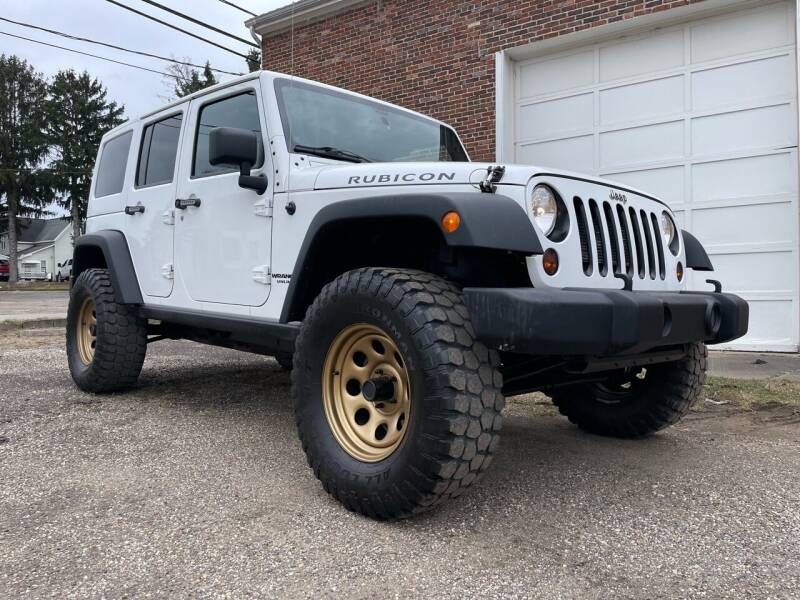 2013 Jeep Wrangler Unlimited for sale at Jim's Hometown Auto Sales LLC in Cambridge OH