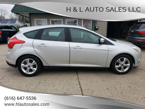 2014 Ford Focus for sale at H & L AUTO SALES LLC in Wyoming MI