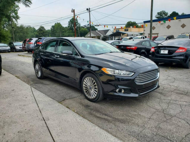 2016 Ford Fusion for sale at DAGO'S AUTO SALES LLC in Dalton, GA