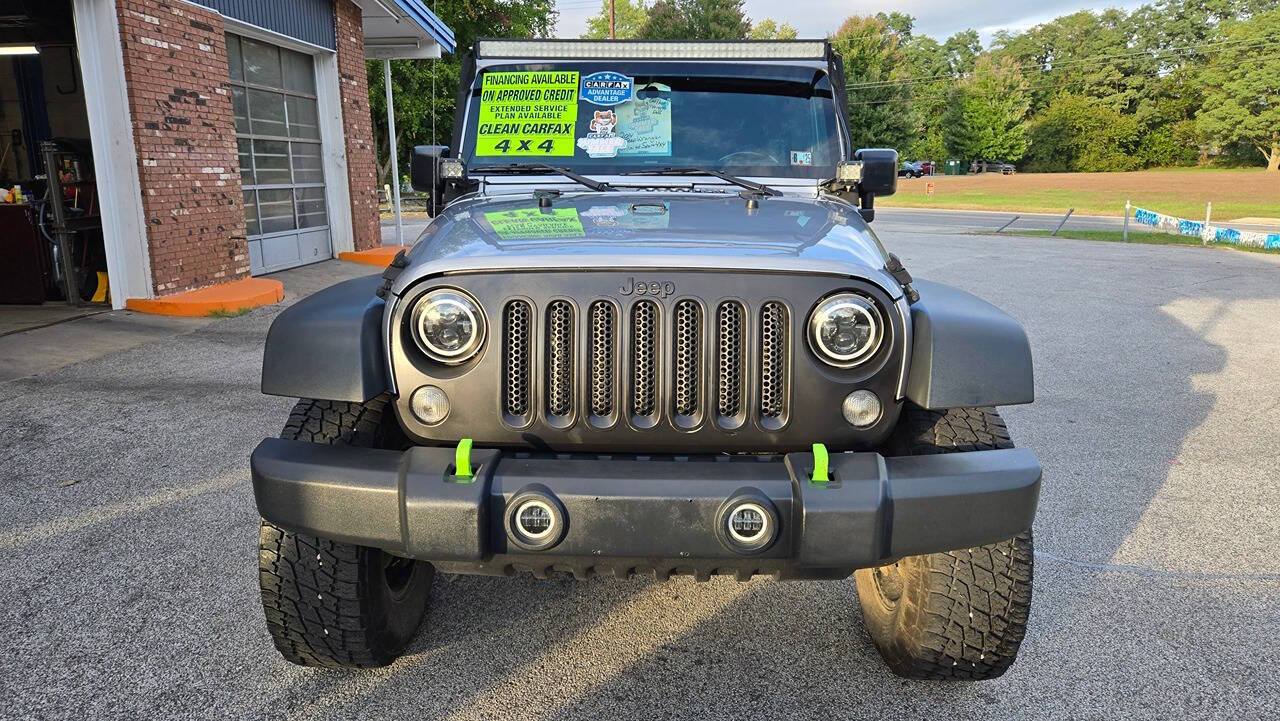 2014 Jeep Wrangler Unlimited for sale at North Ridge Auto Center LLC in Madison, OH