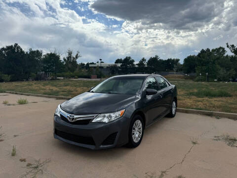 2014 Toyota Camry for sale at QUEST MOTORS in Centennial CO