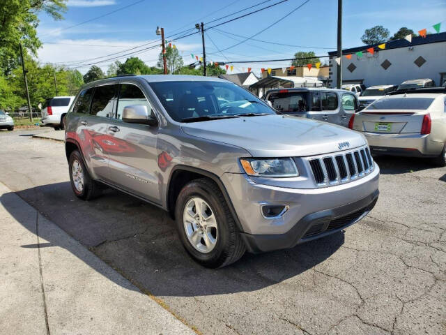 2014 Jeep Grand Cherokee for sale at DAGO'S AUTO SALES LLC in Dalton, GA