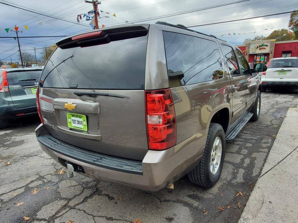 2013 Chevrolet Suburban for sale at DAGO'S AUTO SALES LLC in Dalton, GA