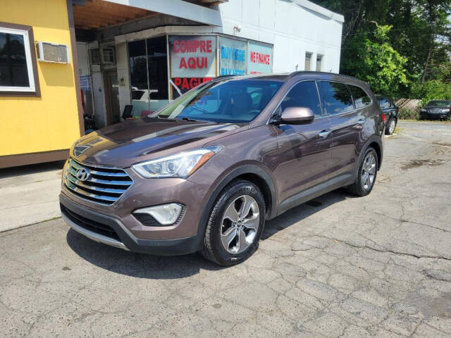 2015 Hyundai SANTA FE for sale at DAGO'S AUTO SALES LLC in Dalton, GA