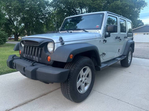 2012 Jeep Wrangler Unlimited for sale at The Car Mart in Milford IN