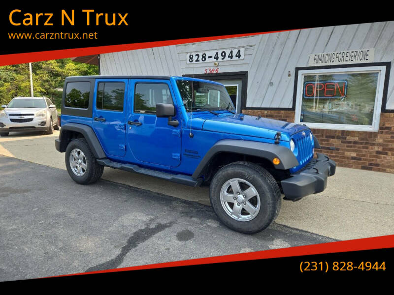 2014 Jeep Wrangler Unlimited for sale at Carz N Trux in Twin Lake MI