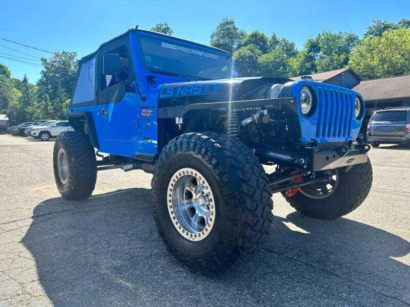 1997 Jeep Wrangler for sale at Rombaugh's Auto Sales in Battle Creek MI
