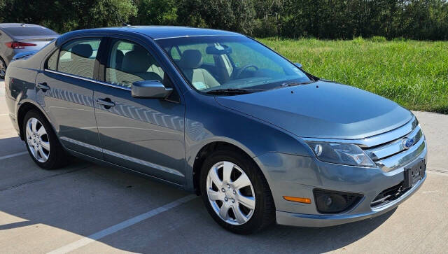 2011 Ford Fusion for sale at CAR MARKET AUTO GROUP in Sugar Land, TX