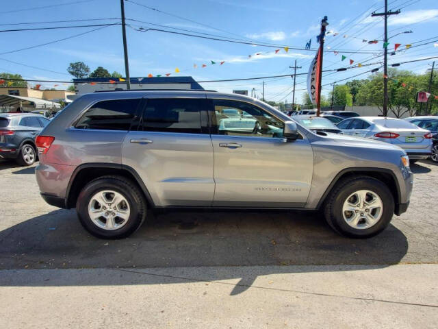 2014 Jeep Grand Cherokee for sale at DAGO'S AUTO SALES LLC in Dalton, GA