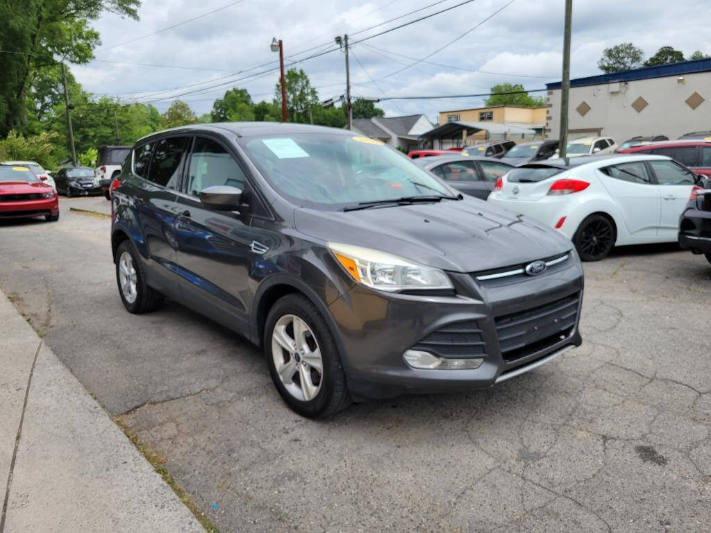 2015 Ford Escape for sale at DAGO'S AUTO SALES LLC in Dalton, GA