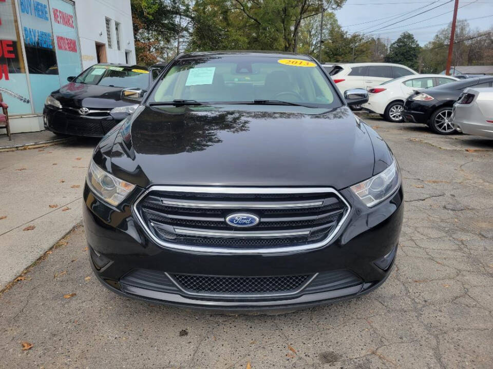 2013 Ford Taurus for sale at DAGO'S AUTO SALES LLC in Dalton, GA