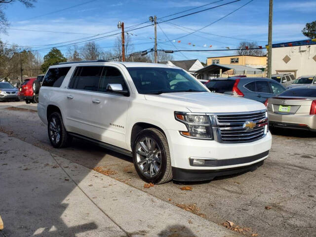 2015 Chevrolet Suburban for sale at DAGO'S AUTO SALES LLC in Dalton, GA