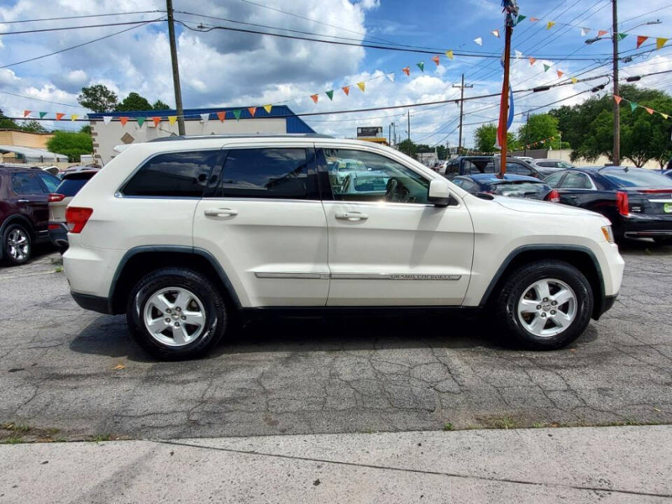 2011 Jeep Grand Cherokee for sale at DAGO'S AUTO SALES LLC in Dalton, GA