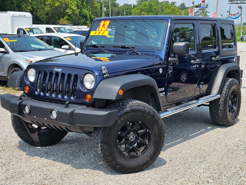 2013 Jeep Wrangler Unlimited for sale at CARMEAN AUTO GROUP LLC in Carroll OH