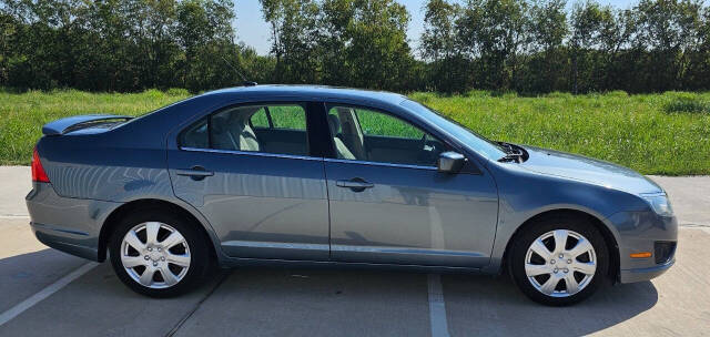 2011 Ford Fusion for sale at CAR MARKET AUTO GROUP in Sugar Land, TX