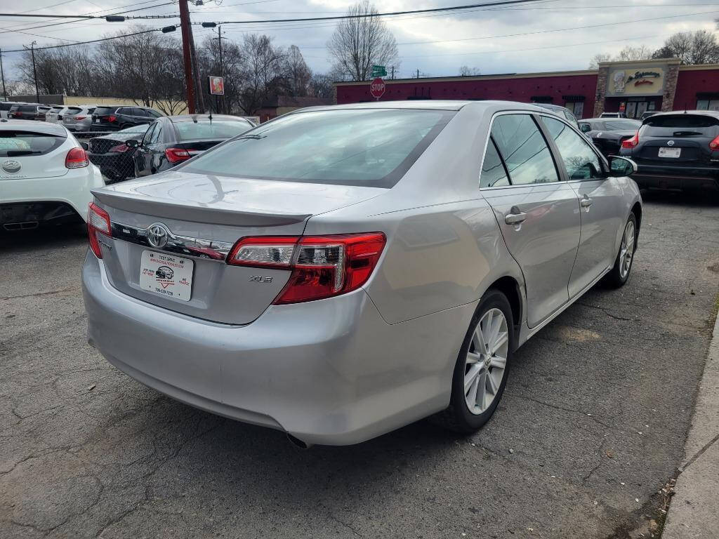 2012 Toyota Camry for sale at DAGO'S AUTO SALES LLC in Dalton, GA