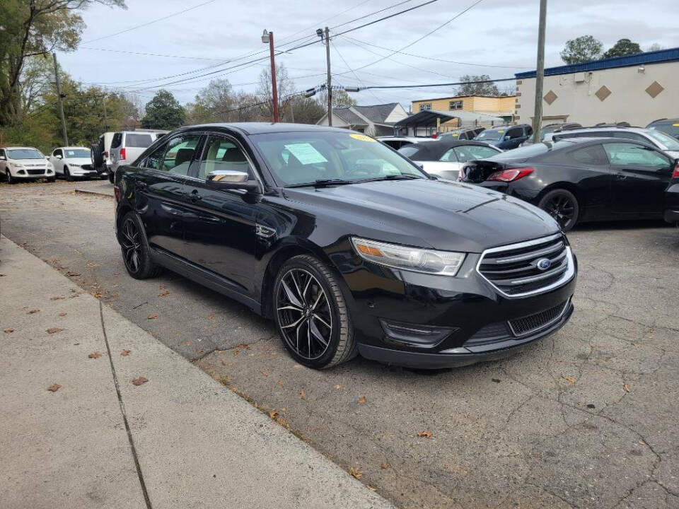 2013 Ford Taurus for sale at DAGO'S AUTO SALES LLC in Dalton, GA