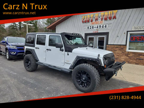 2012 Jeep Wrangler Unlimited for sale at Carz N Trux in Twin Lake MI