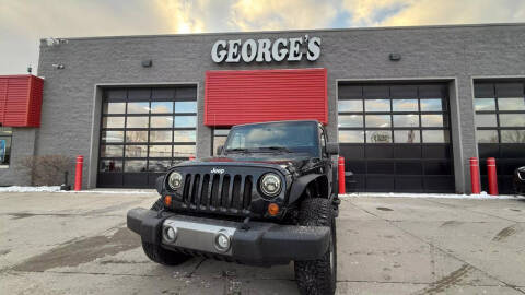 2011 Jeep Wrangler Unlimited for sale at George's Used Cars in Brownstown MI