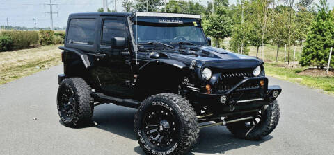 2013 Jeep Wrangler for sale at BOOST MOTORS LLC in Sterling VA