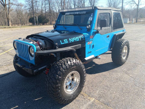 1997 Jeep Wrangler for sale at Rombaugh's Auto Sales in Battle Creek MI