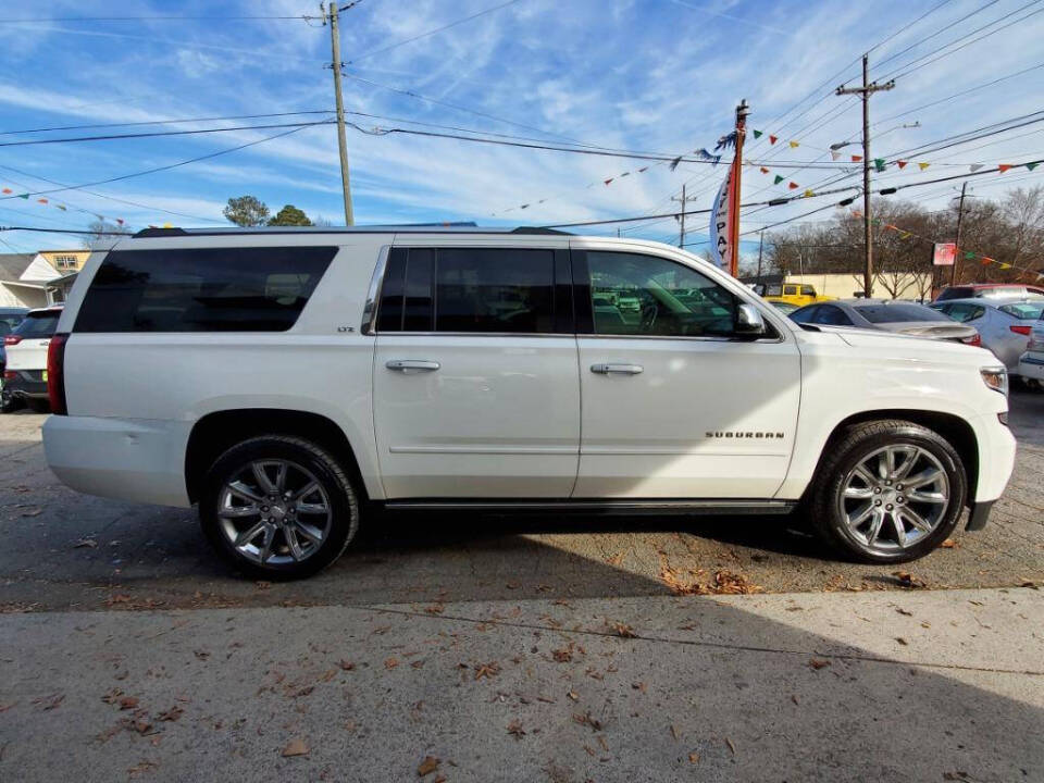 2015 Chevrolet Suburban for sale at DAGO'S AUTO SALES LLC in Dalton, GA