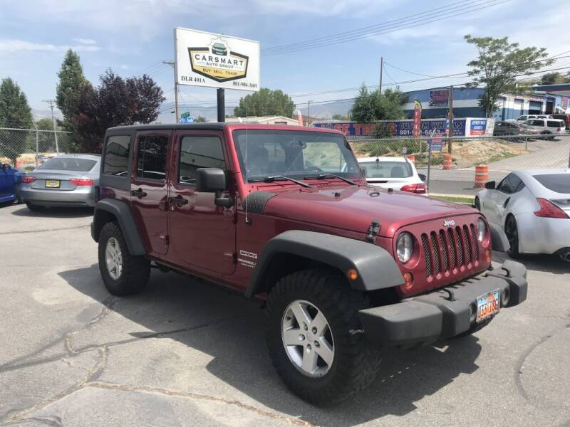 2013 Jeep Wrangler Unlimited for sale at CarSmart Auto Group in Murray UT