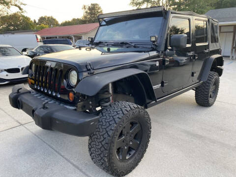 2011 Jeep Wrangler Unlimited for sale at Auto Class in Alabaster AL