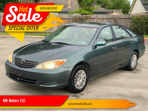 2003 Toyota Camry for sale at KM Motors LLC in Houston TX