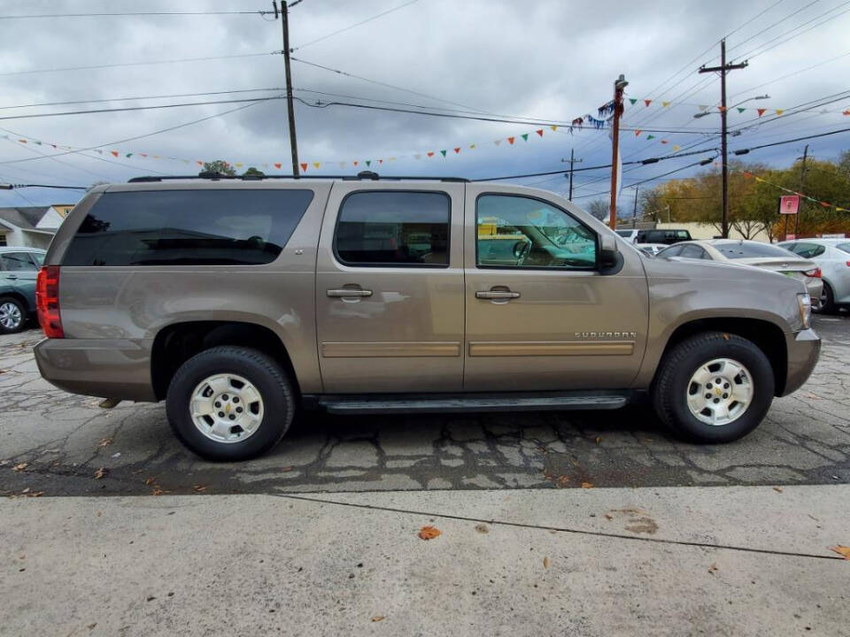 2013 Chevrolet Suburban for sale at DAGO'S AUTO SALES LLC in Dalton, GA