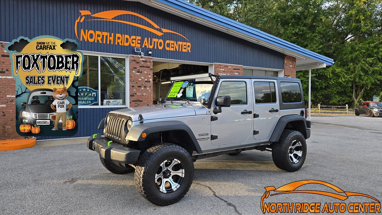 2014 Jeep Wrangler Unlimited for sale at North Ridge Auto Center LLC in Madison, OH