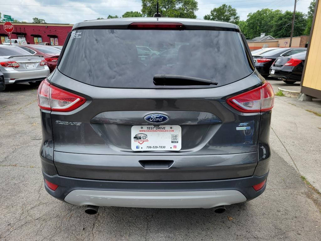 2015 Ford Escape for sale at DAGO'S AUTO SALES LLC in Dalton, GA