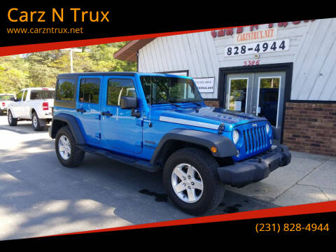 2014 Jeep Wrangler Unlimited for sale at Carz N Trux in Twin Lake MI