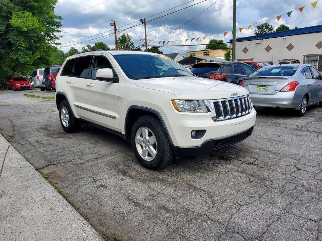 2011 Jeep Grand Cherokee for sale at DAGO'S AUTO SALES LLC in Dalton, GA