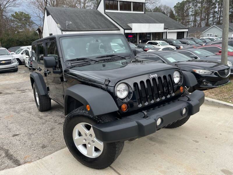 2013 Jeep Wrangler Unlimited for sale at Alpha Car Land LLC in Snellville GA