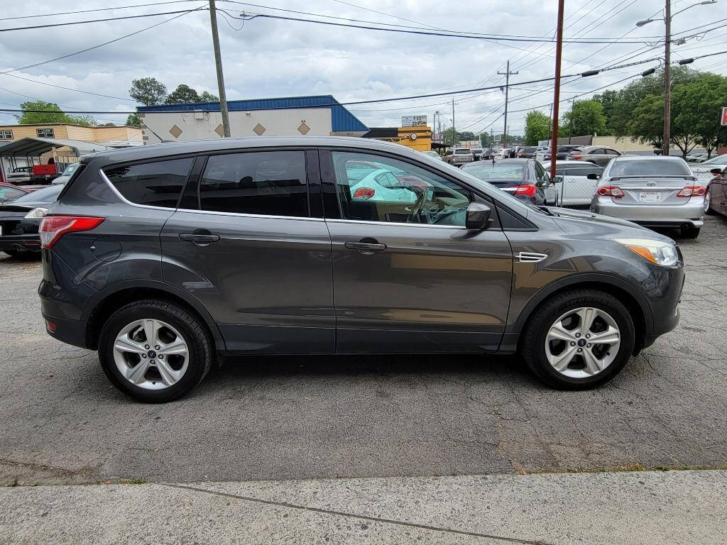 2015 Ford Escape for sale at DAGO'S AUTO SALES LLC in Dalton, GA