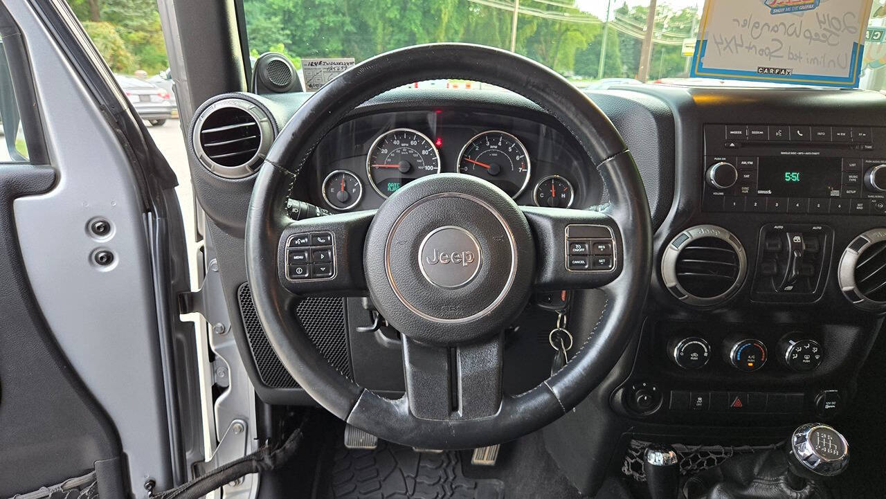 2014 Jeep Wrangler Unlimited for sale at North Ridge Auto Center LLC in Madison, OH