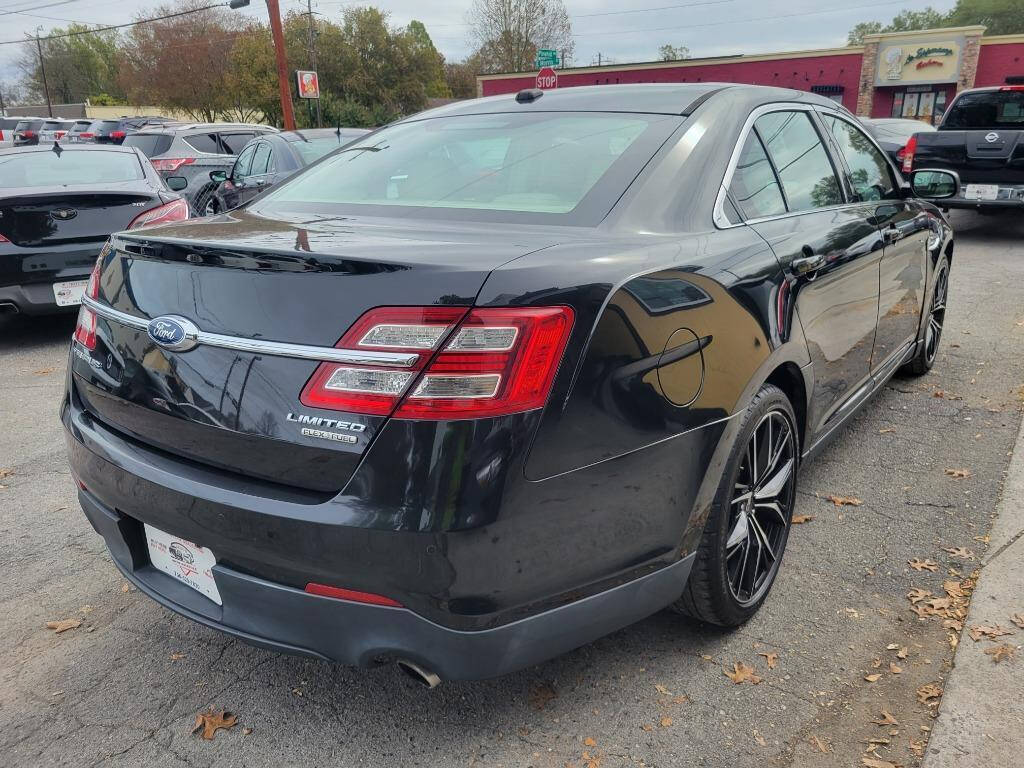 2013 Ford Taurus for sale at DAGO'S AUTO SALES LLC in Dalton, GA