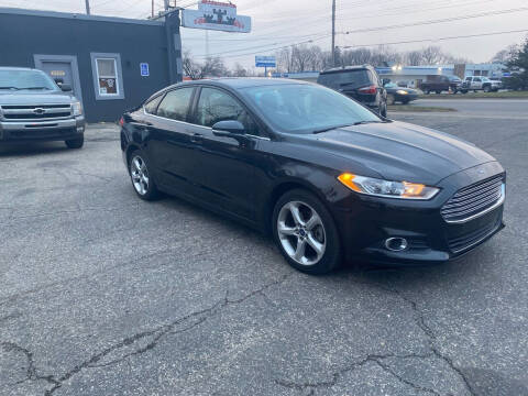 2014 Ford Fusion for sale at Castle Cars Inc. in Lansing MI