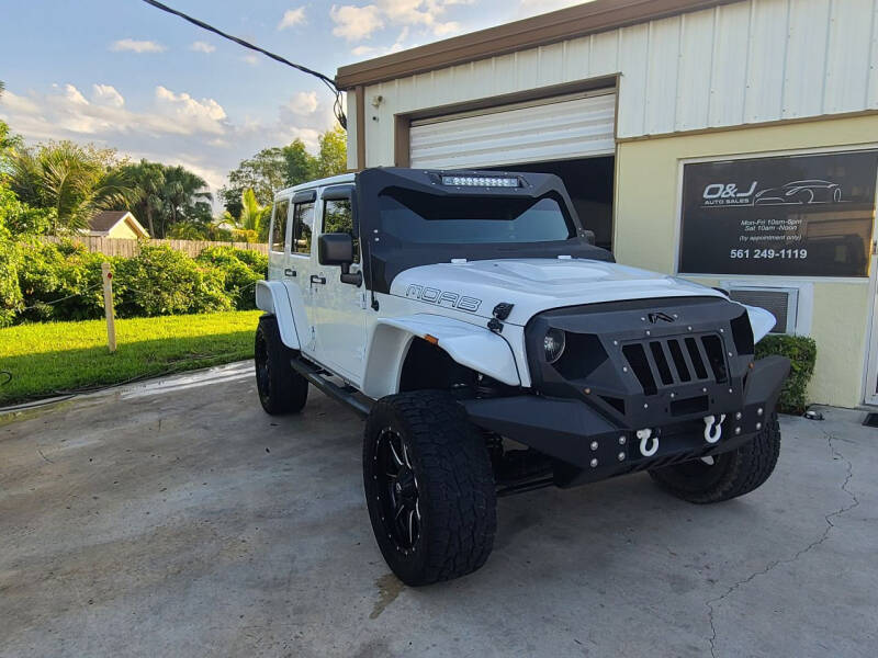 2013 Jeep Wrangler Unlimited for sale at O & J Auto Sales in Royal Palm Beach FL