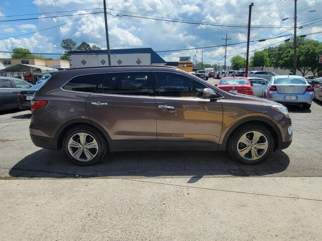 2015 Hyundai SANTA FE for sale at DAGO'S AUTO SALES LLC in Dalton, GA