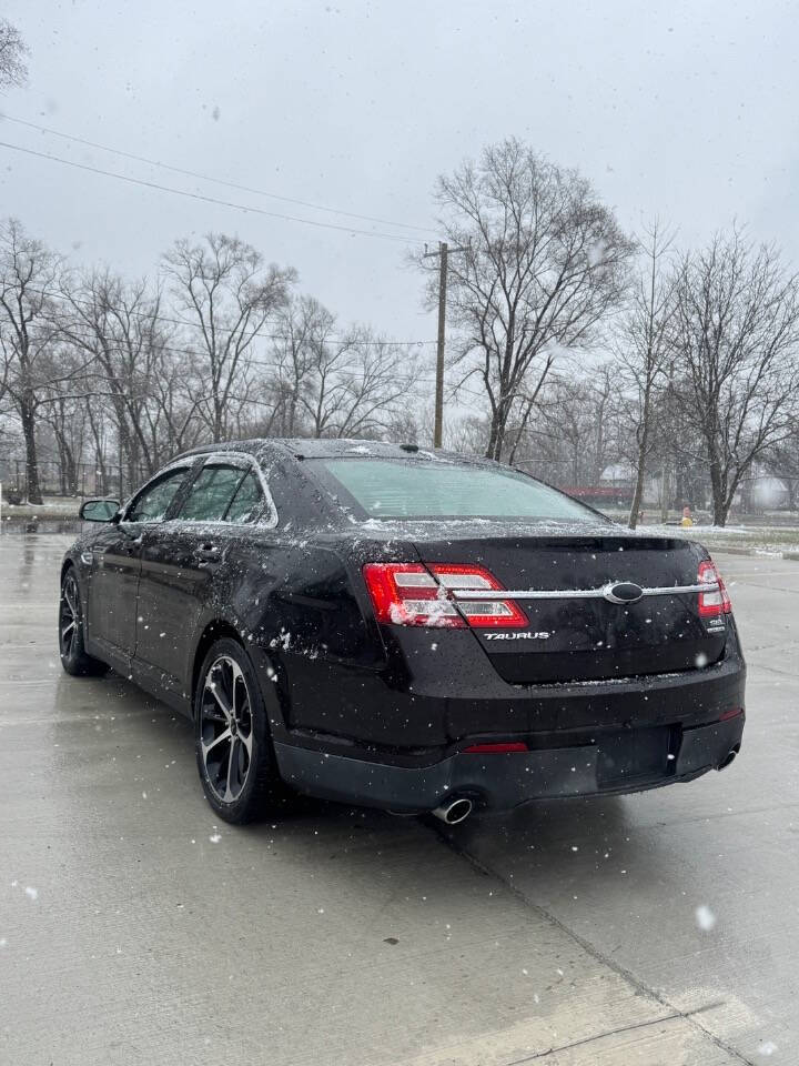 2014 Ford Taurus for sale at H & H AUTO GROUP in Detroit, MI