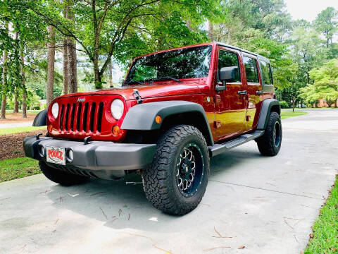 2011 Jeep Wrangler Unlimited for sale at Poole Automotive in Laurinburg NC
