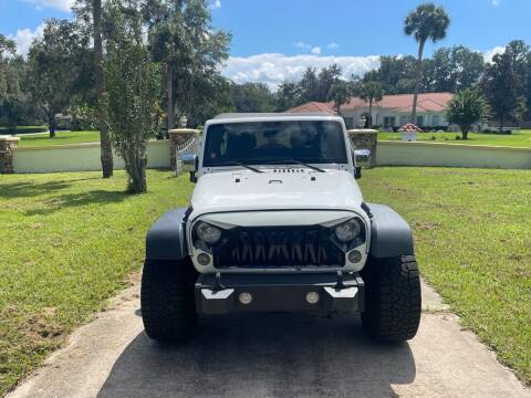 2014 Jeep Wrangler Unlimited for sale at Louie's Auto Sales in Leesburg FL