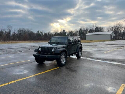 2010 Jeep Wrangler Unlimited for sale at Caruzin Motors in Flint MI