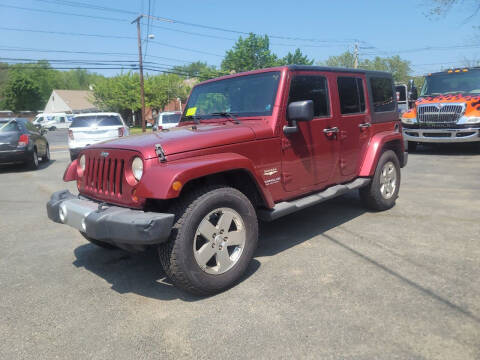 2011 Jeep Wrangler Unlimited for sale at Hometown Automotive Service & Sales in Holliston MA